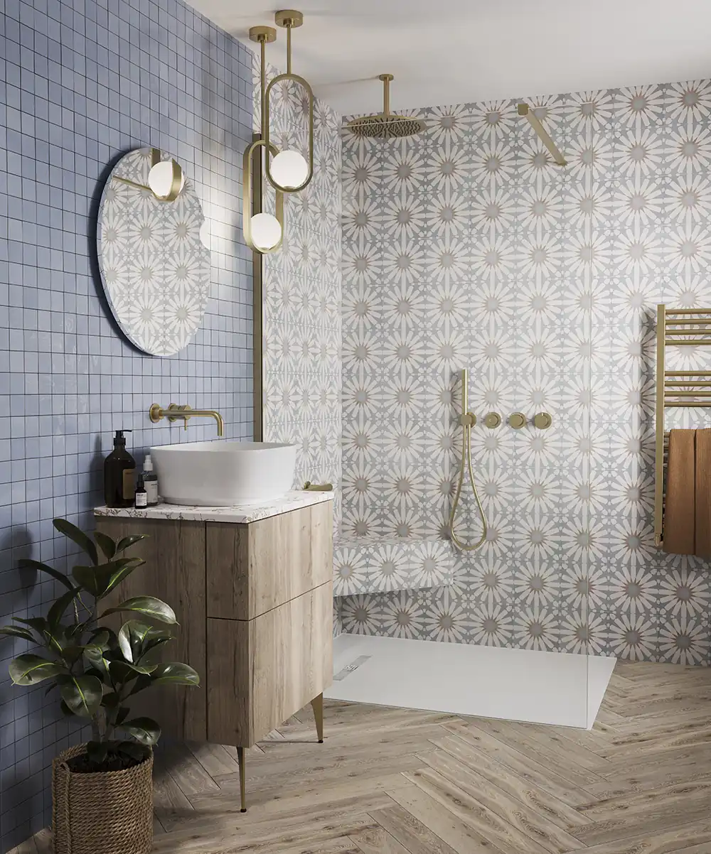 Modern bathroom with geometric tiles, wooden vanity, round mirror, and gold fixtures. Potted plant and unique lighting add a stylish touch.