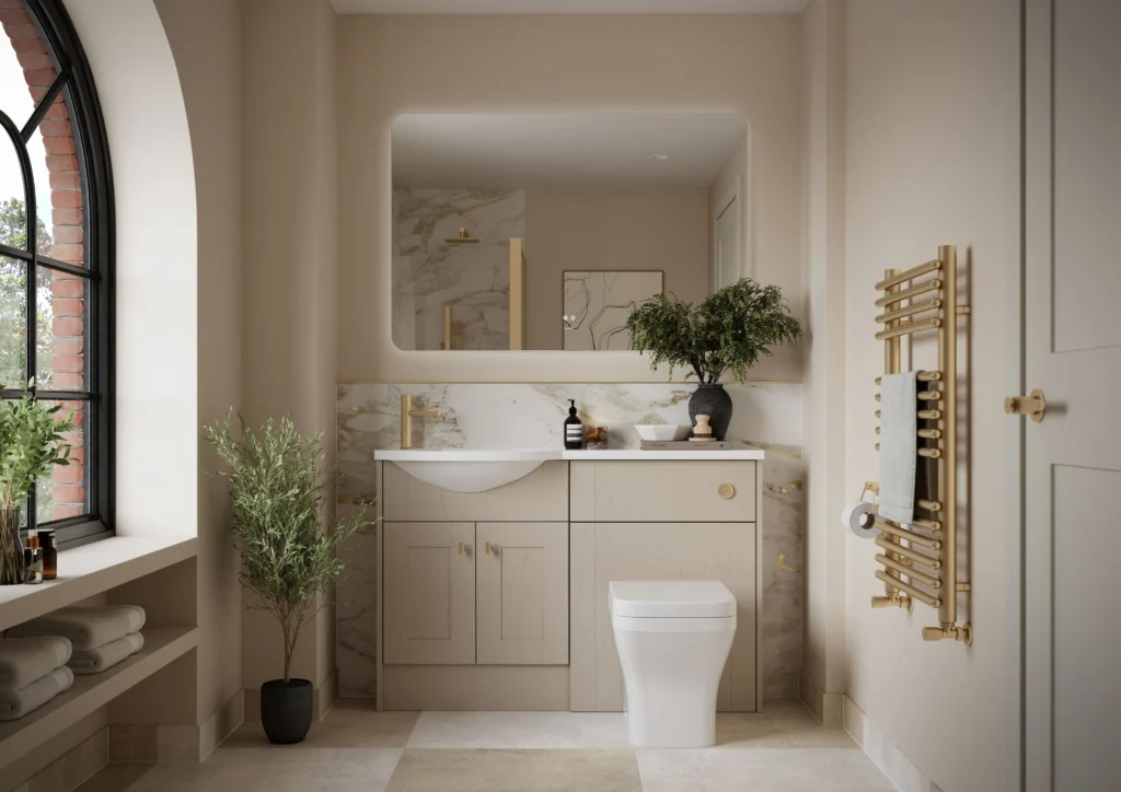 Modern bathroom with large mirror, arched window, and plants. Features a vanity with gold accents and a heated towel rail. Neutral tones throughout.