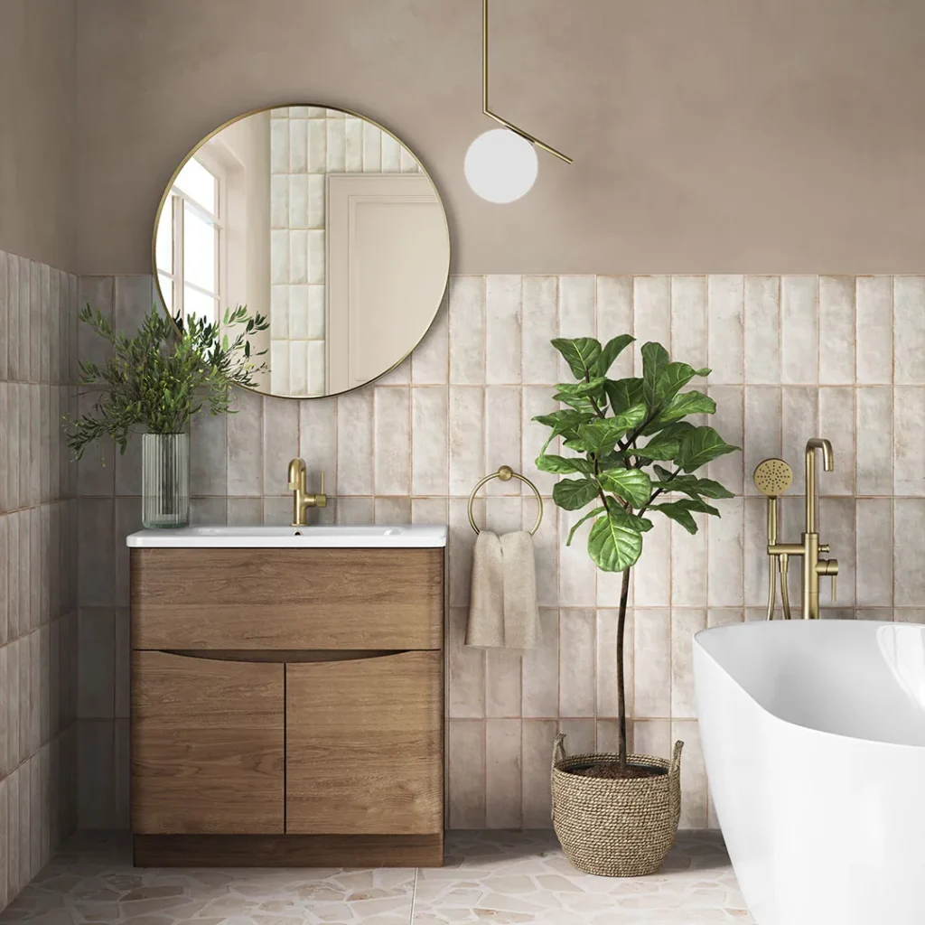 A modern bathroom with a wooden vanity, round mirror, potted plant, and freestanding bathtub, combining natural and minimalist design elements.
